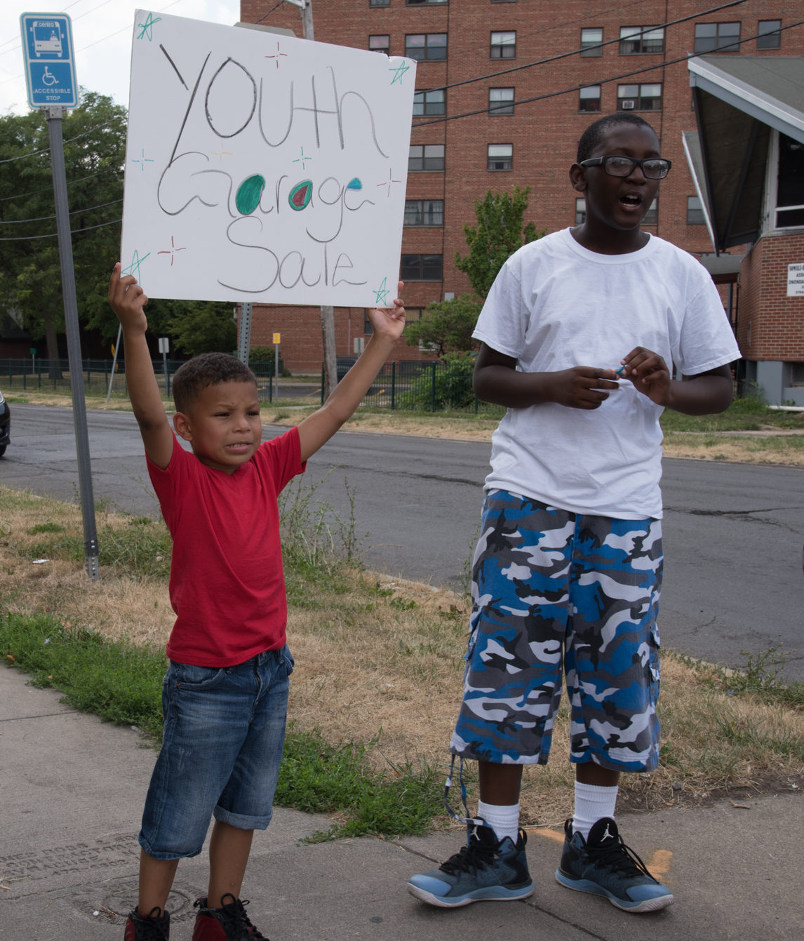 A young boy holds a sign promoting a fundraiser held at the Central Village Boys & Girls Club.