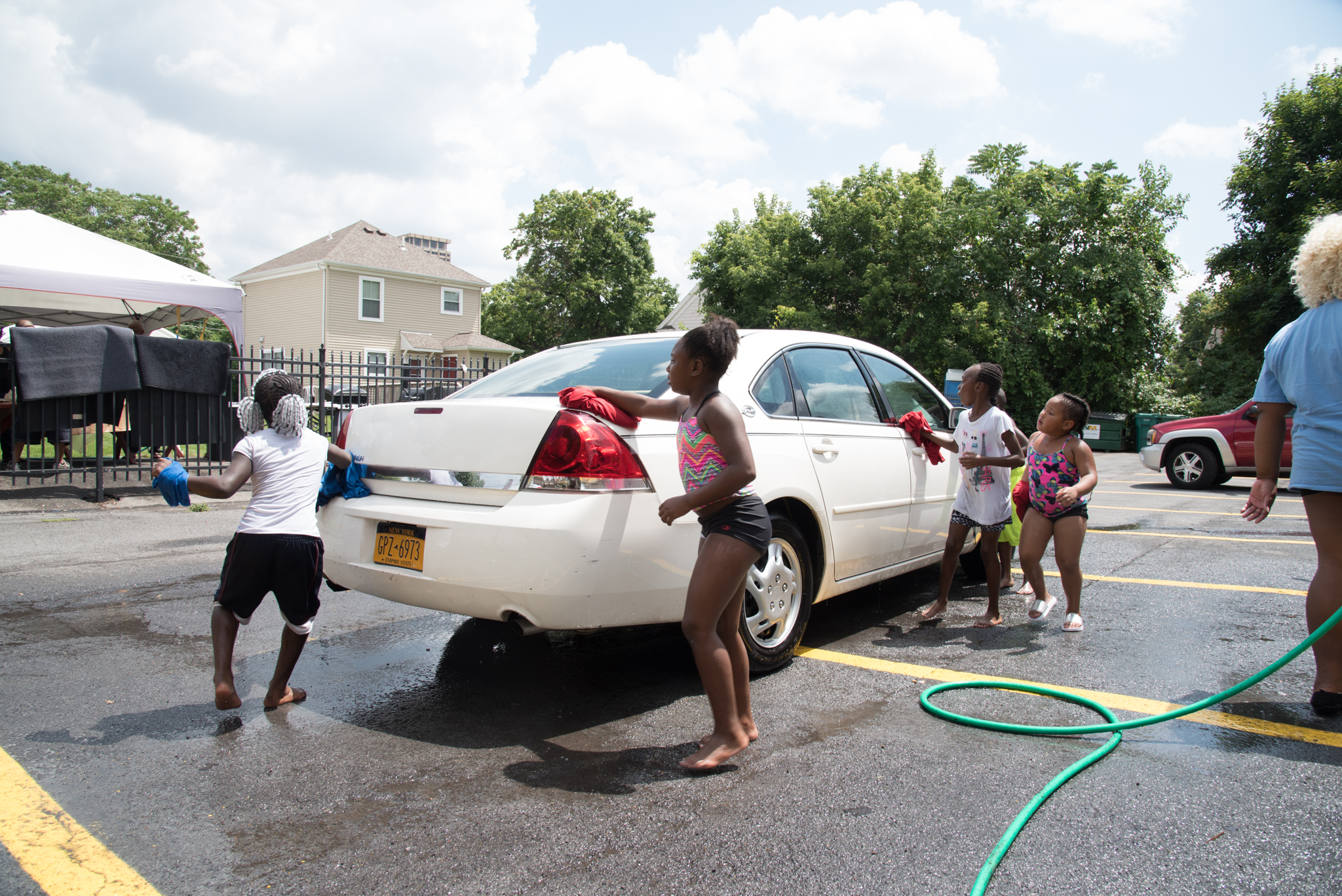 Youth at the Central Village Boys & Girls Club wash cars July 22. | Photo by Marianne Barthelemy