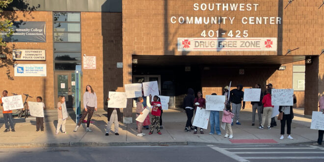Protesters in front of the Southwest Community Center. The protesters want to know why a popular afterschool program was suddenly canceled and are demanding that the program re-start as soon as possible. Photo by Za'Tozia Duffie